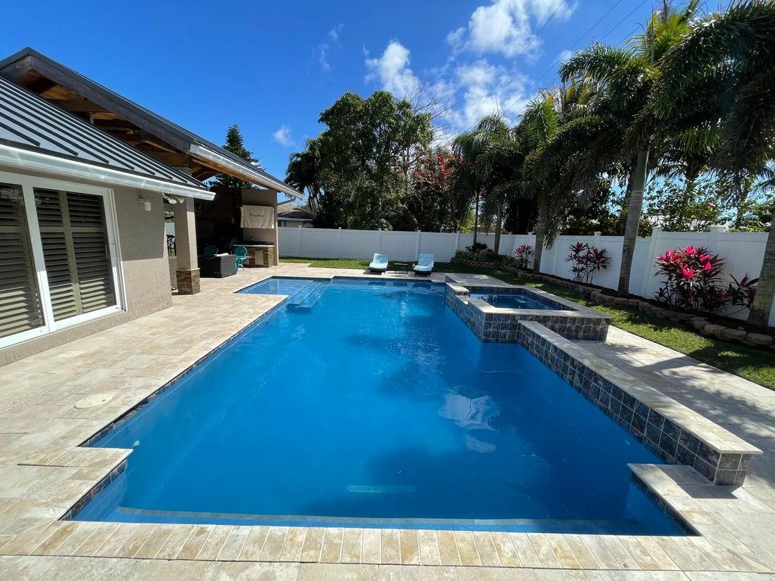 Remodeled pool with raised spa and travertine deck